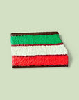 Colorful layered dessert on a light green background