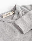 Gray fleece garment with a brand label on a white background