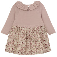Children's dress with ribbed sweater top and floral skirt on a white background