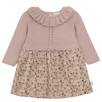 Two-tone dress with ruffled collar and floral skirt on a white background