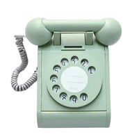 Mint green rotary phone on a white background