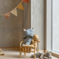Children's room with plush toys and a round hanging decoration.