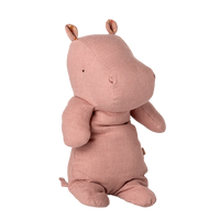 Pink plush hippo toy on a white background