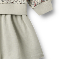 Children's outfit with floral jacket and beige skirt on a white background