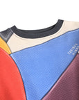 Colorful patchwork sweatshirt with a brand logo on a white background