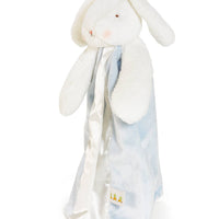 White bunny plush toy with a soft, patterned blanket draped over it on a white background