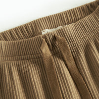 Close-up of brown pants on a white background