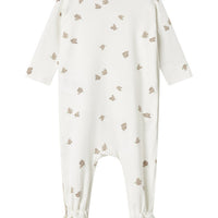 White baby onesie with small pattern on a white background