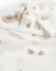 Close-up of a baby outfit with bear patterns and a Marmar Copenhagen tag on a white background.