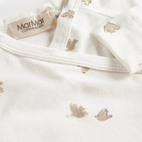 Close-up of a baby outfit with bear patterns and a Marmar Copenhagen tag on a white background.