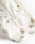 White fabric with gold dove prints on a white background