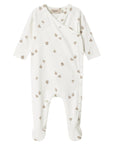 White baby onesie with small patterns on a white background