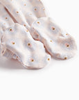 Pair of light pink socks with small floral patterns on a white background