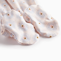 Pair of light pink socks with small floral patterns on a white background