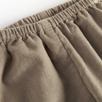 Close-up of beige corduroy pants on a white background