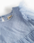 Light blue dress with tulle details on a white background