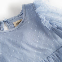 Light blue dress with tulle details on a white background