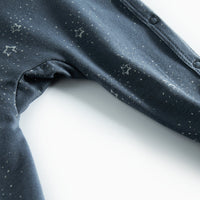 Close-up of dark fabric with star patterns on a white background