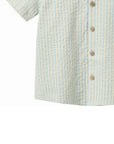 Close-up of a short-sleeve shirt with a striped pattern and wooden buttons on a white background