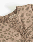 Close-up of a children's long-sleeve shirt with a beige and brown leopard print pattern, featuring a mandarin collar and button-down front.
