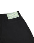 Black pants with a 'Curiosity' label on a white background