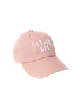 Pink cap with 'LITTLE SIS' text on a white background