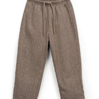 Brown woven pants on a white background