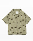 Green shirt with palm tree pattern on a white background