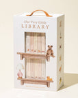 Box packaging for 'Our Very Little Library' with illustrations of books and a teddy bear.