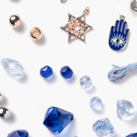 Collection of jewelry charms and beads on a white background