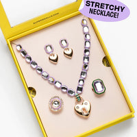 Necklace set with heart and gemstone pendants in a yellow box, labeled 'Stretchy Necklace'.