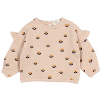 Beige sweater with floral pattern and ruffled sleeves on a white background