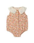 Baby romper with floral pattern and white collar on a white background