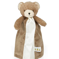 Brown teddy bear with a white blanket on a white background