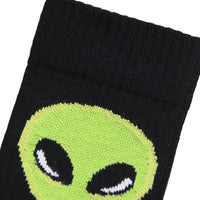 Black sock with a green alien face design on a white background