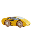 Yellow toy car with wooden wheels on a beige background