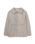 A light gray wool-blend button-up shirt jacket with a collar, two front patch pockets, and brown buttons, shown flat on a white background. The brand name 'comodo' is visible on the inner neck label.