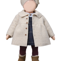 Doll wearing a beige coat, hat, and boots on a white background