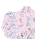 A close-up of a pink long-sleeve top featuring a repeating print of white unicorns and small floral details in blue, pink, and yellow.