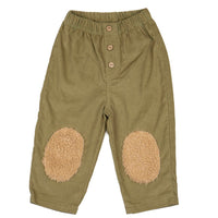 Green pants with beige patches on a white background