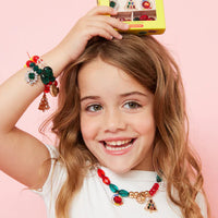 Young girl wearing colorful jewelry with a pink background