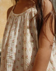 Person wearing a floral dress with a blurred background