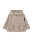 A beige hooded cardigan with brown buttons and decorative brown trim on the front pockets, shown flat on a light gray background.
