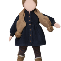 Doll wearing a navy dress with brown buttons, knitted scarf, and hat on a white background