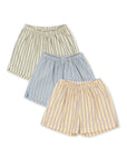 Three striped skirts in green, blue, and beige on a white background