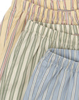 Three pairs of striped pants in beige, green, and blue.