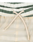 Close-up of a drawstring on a green and white striped fabric