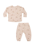A two-piece children's pajama set featuring a long-sleeve top and matching pants in a light beige color with an all-over brown deer print, displayed on a solid white background.