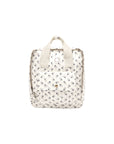 A small cream-colored backpack with a delicate black floral print, featuring top handles and a front pocket, shown against a plain white background.