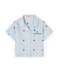 Light blue shirt with red polka dots on a white background